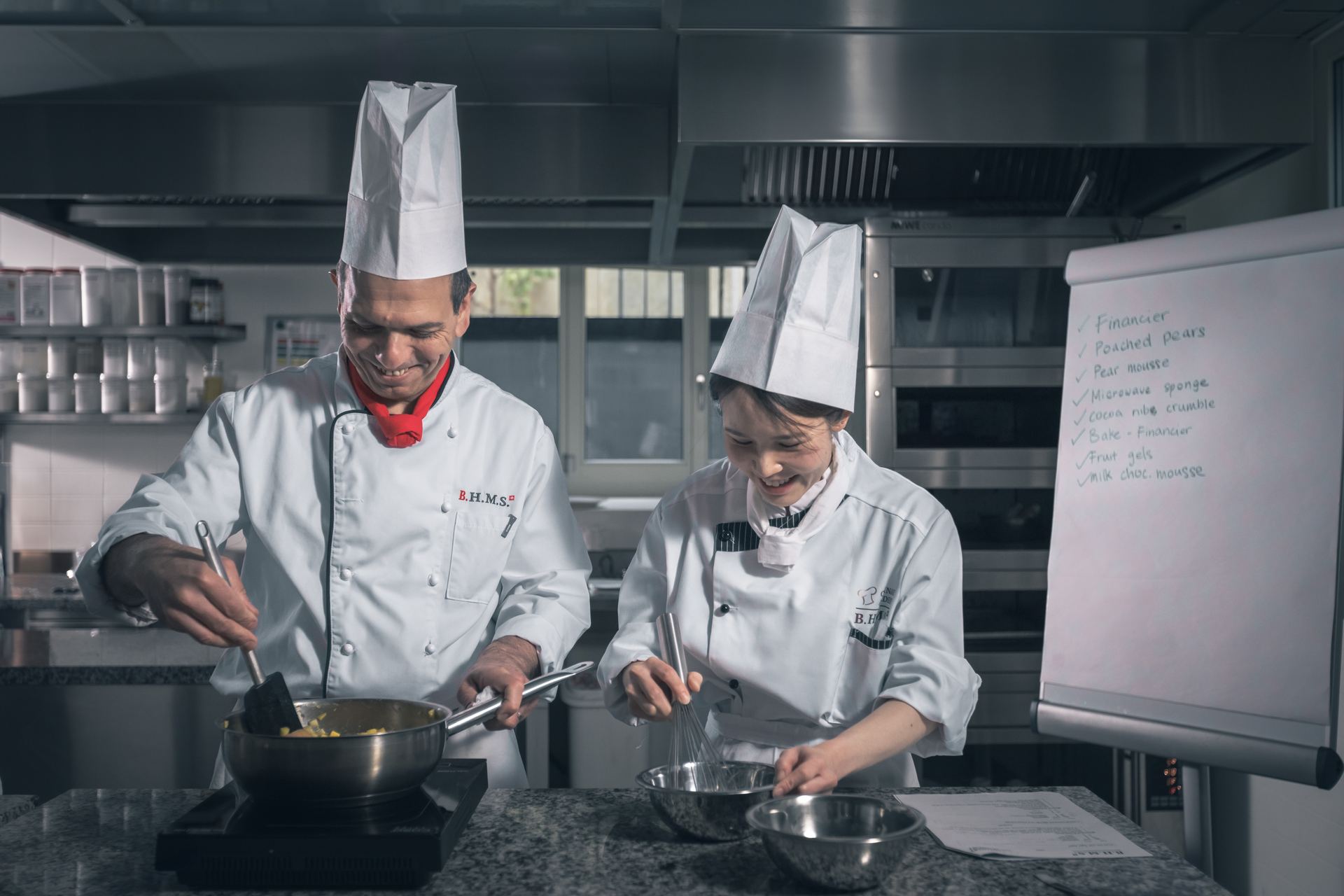 BHMS chef instructor and student preparing patisserie in the teaching kitchen