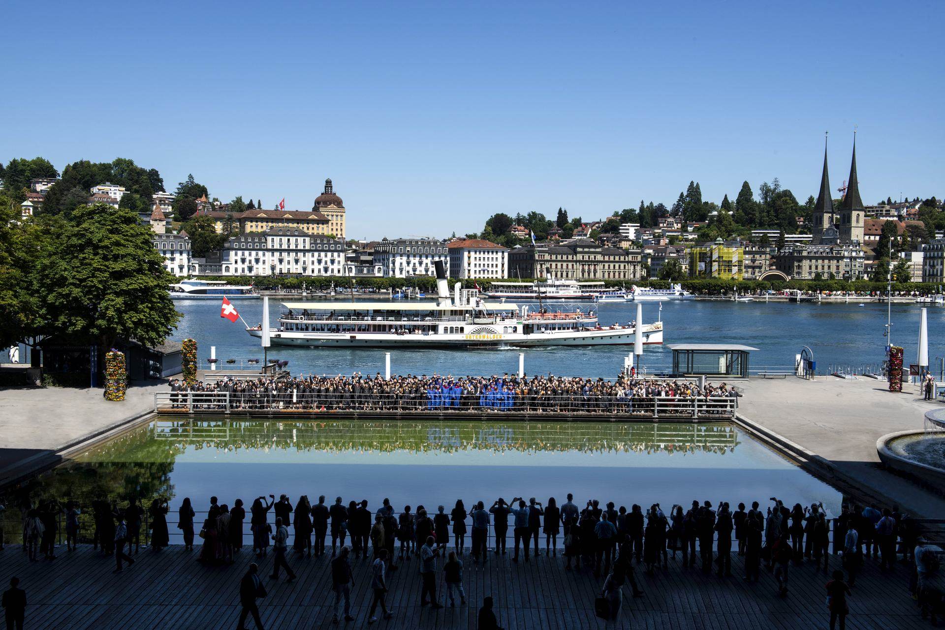 BHMS graduates celebrating in gowns on the Lucerne waterfront