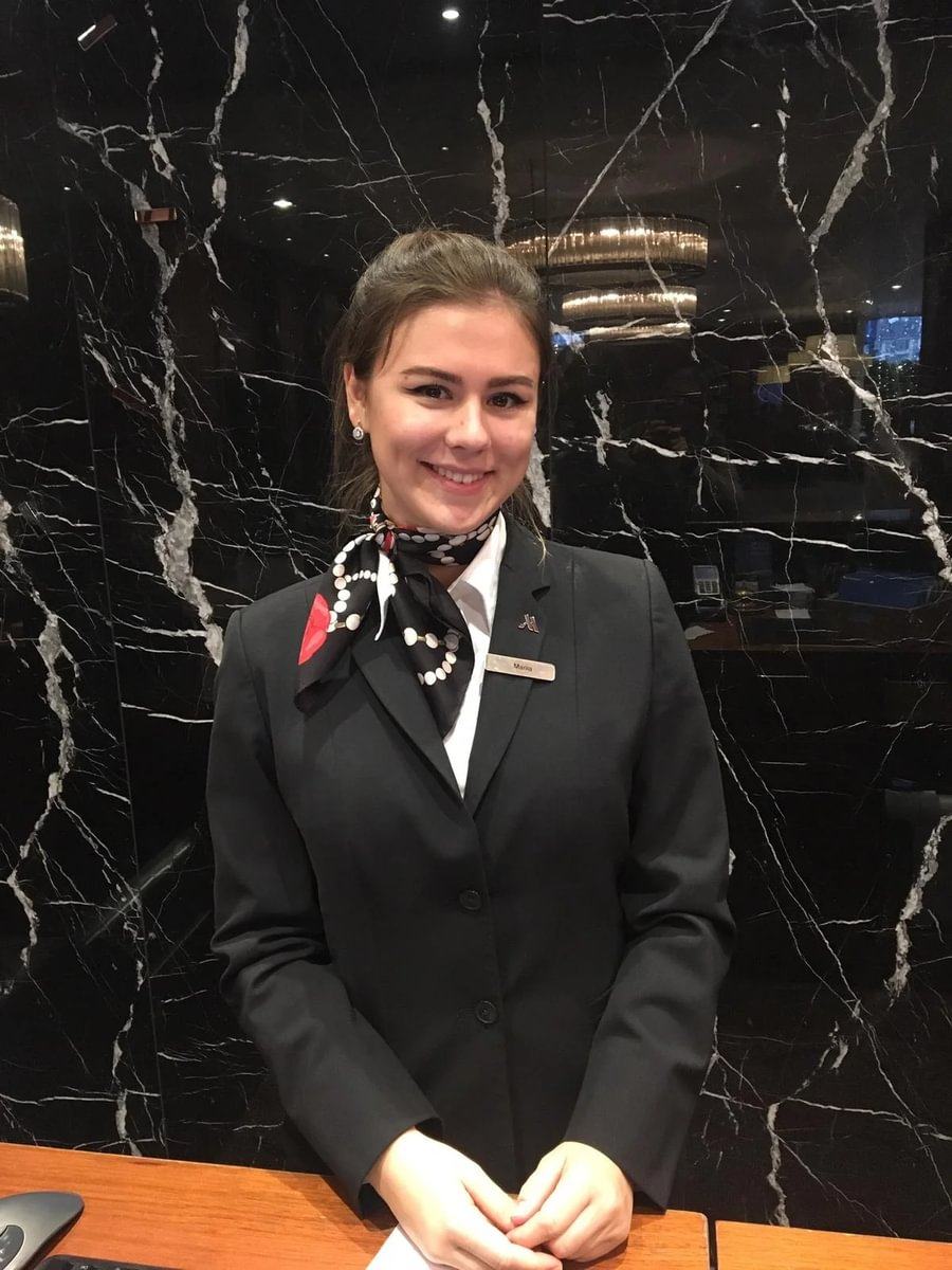 BHMS student working at a hotel front-office desk during an industry placement