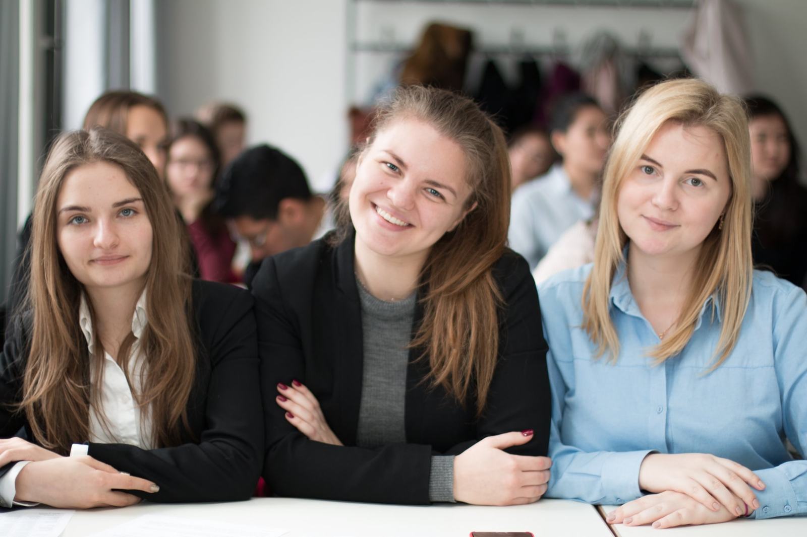 BHMS students in business dress seated together in a bright classroom